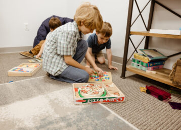 two kids playing a game on the floor at the chapel ocala church, located in ocala, florida